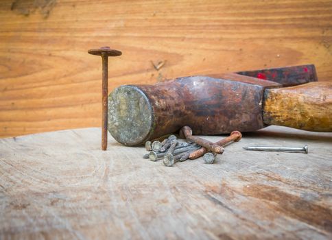 Old hammer and nails on the wood