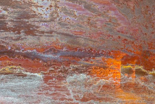 rusty iron surface covered with old chipped paint, which has long been influenced by different climatic conditions
