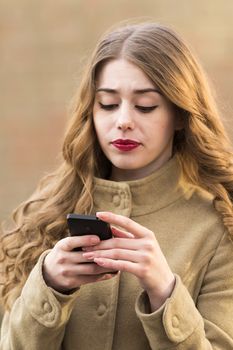 girl reads a message on your mobile phone