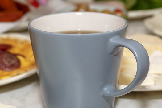 Close up detailed view of a mug with tea inside.