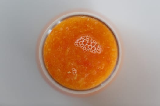 Close up detailed top view of fresh orange juice in a glass