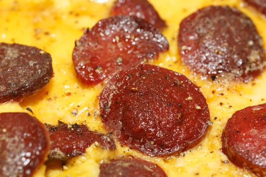 Close up detailed view of tasy omelette with sausage.