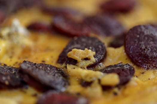 Close up detailed view of tasy omelette with sausage.