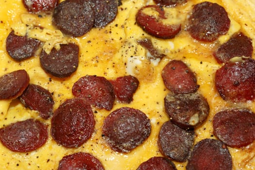 Close up detailed view of tasy omelette with sausage.