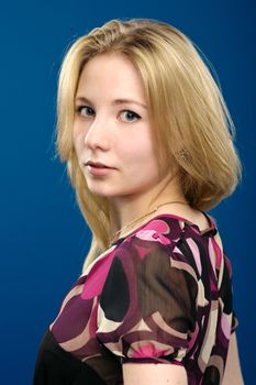 Beautiful girl portrait isolated on blue background.