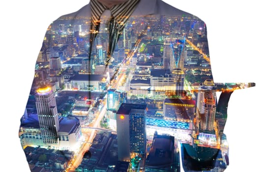 Double exposure of a businessman and a city using a tablet over white background