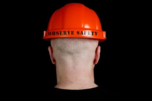 Construction worker in hard hat with an inscription observe safety on gray background