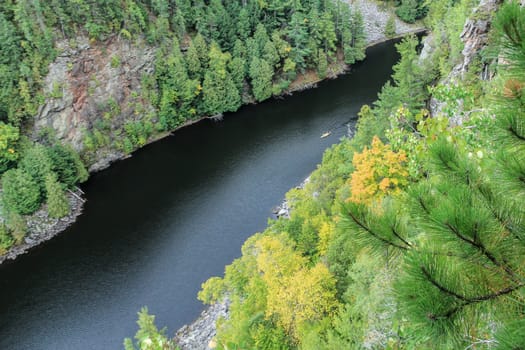 A canoe down below on the Barron River as seen from the cliffs of the Barron Canyon in Algonquin Park, Ontario, Canada