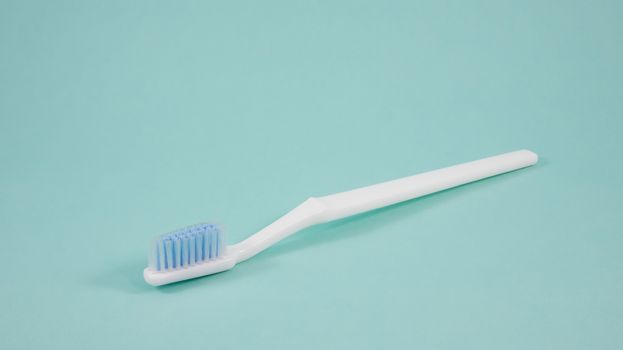 The clean white toothbrush for brushing the teeth.