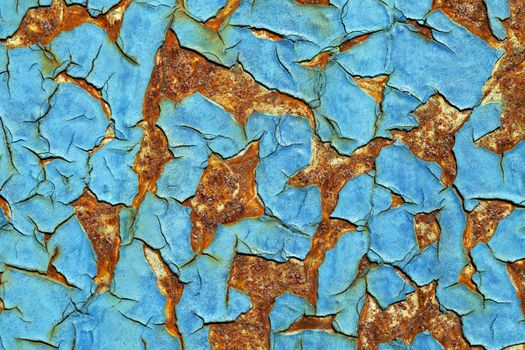 Close-up of peeling paint and rust on a wall
