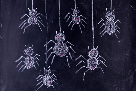 Graphic representation with chalk on the blackboard of arachnophobia fear of spiders