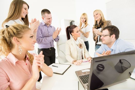 Successful business team congratulates colleague on Successful Presentation with big applauding.