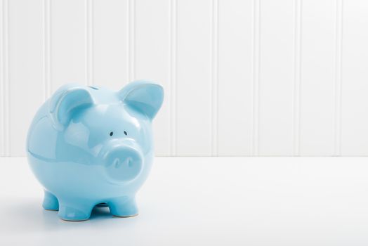 Blue porcelain piggybank with ample copy space.