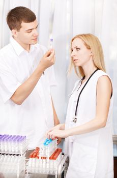 Young people working in the laboratory and checking samples