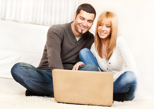 Happy young couple shopping online from home