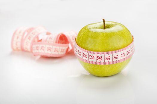 green apple with measuring tape