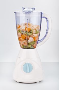 Mixed fresh fruit in blender