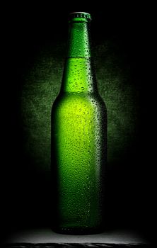 Bottle of green beer on a black background