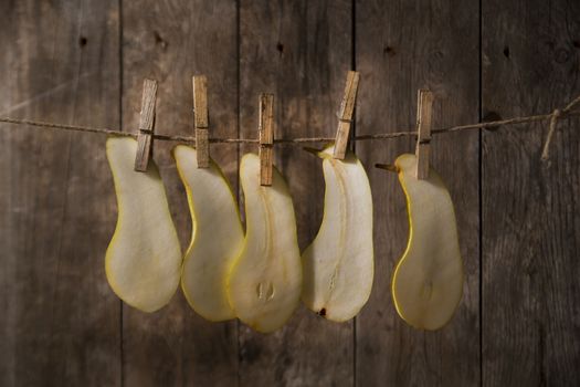 Pear slices williams hung with wire with tweezers