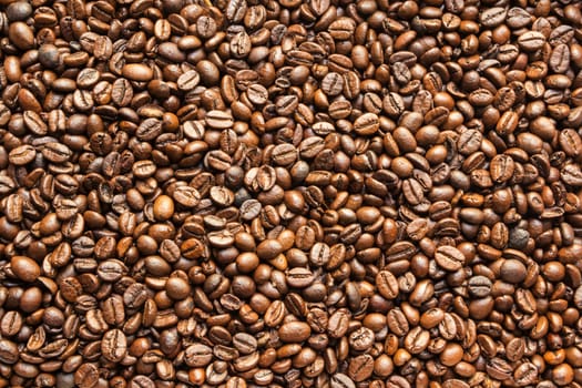 the texture of the coffee beans roasted Brown background