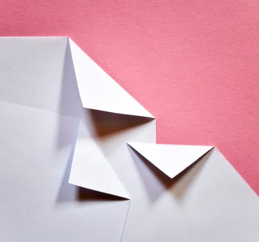 abstract white folded papers ticket on a pink background