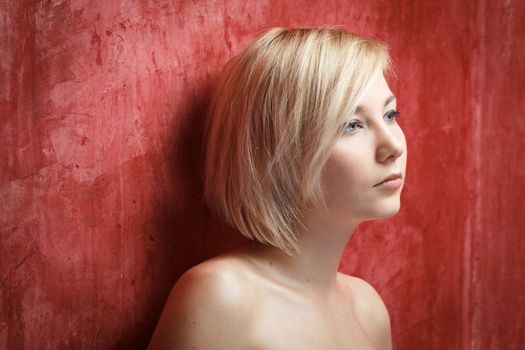 Portrait beautiful woman with elegant white dress on grunge wall background. Fashion photo