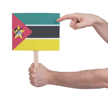 Hand holding small card, isolated on white - Flag of Mozambique