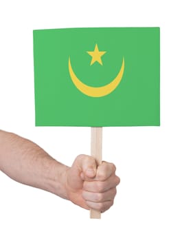 Hand holding small card, isolated on white - Flag of Mauritania