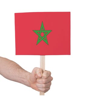 Hand holding small card, isolated on white - Flag of Morocco