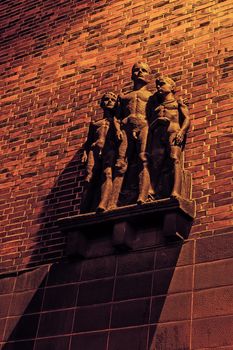 Sculpture of the young boys by German artist Walter Tuckermann on the facade of the school. Created in nazi realism style, survived untouched socialism times.