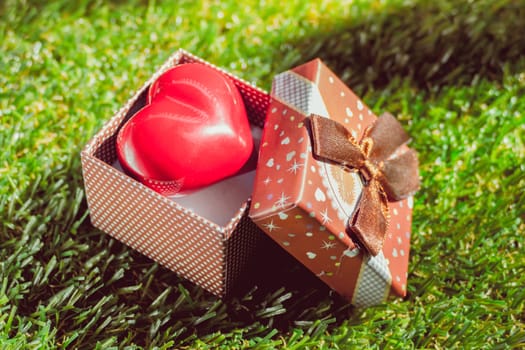 Gift of love. hearty gift. A gift box with a red heart inside. art background