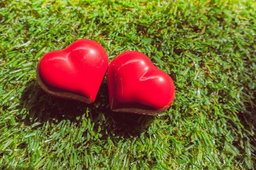 closeup of a red heart on the grass, art background