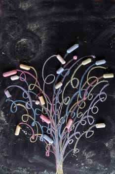 Representation drawn with chalk on the blackboard of a colorful tree