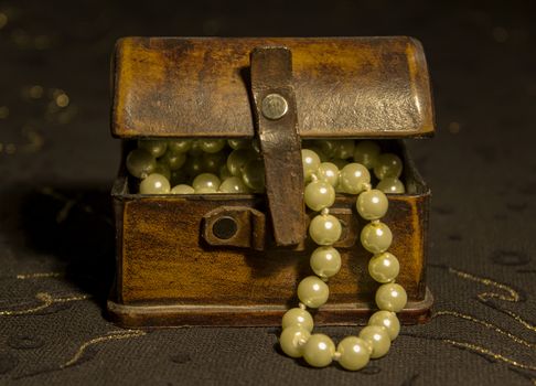 Pearl Necklace in an ancient casket on a dark background