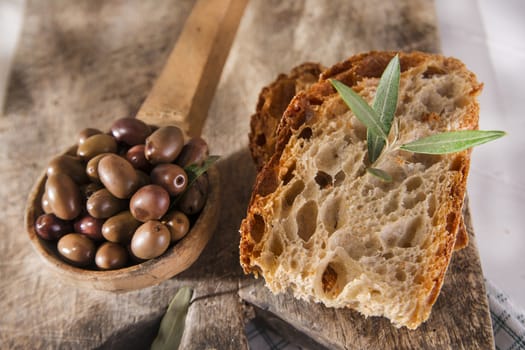 Snack of slice of bread with olives in brine