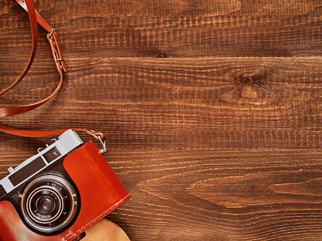 top view image of vintage old camera on wooden table background. Flat lay