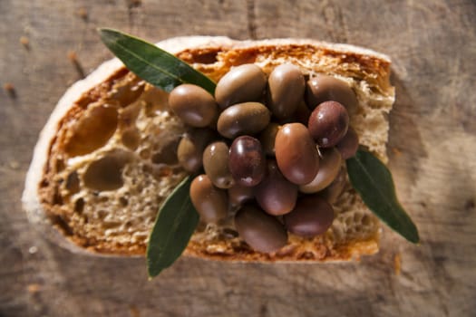 Snack of slice of bread with olives in brine