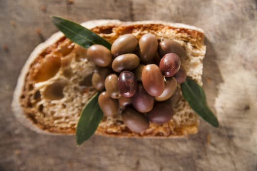 Snack of slice of bread with olives in brine