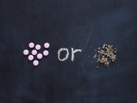 Herbal medicine VS Chemical medicine the alternative healthy care concept on chalkboard. Flat lay or top view