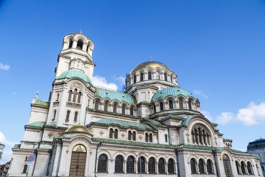 General bottom view of famous Bulgarian Orthodox church of Alexander Nevsky Cathedral built in 1882 in Sofia, Bulgaria, on blue sky background.