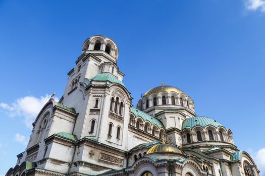 General bottom view of famous Bulgarian Orthodox church of Alexander Nevsky Cathedral built in 1882 in Sofia, Bulgaria, on blue sky background.