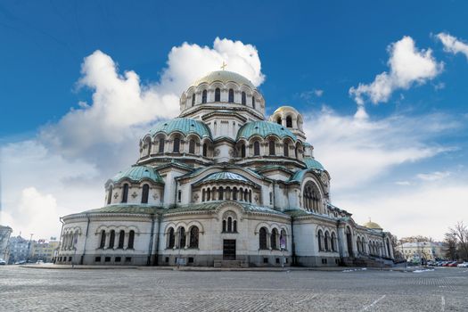 General view of famous Bulgarian Orthodox church of Alexander Nevsky Cathedral built in 1882 in Sofia, Bulgaria, on cloudy blue sky background.