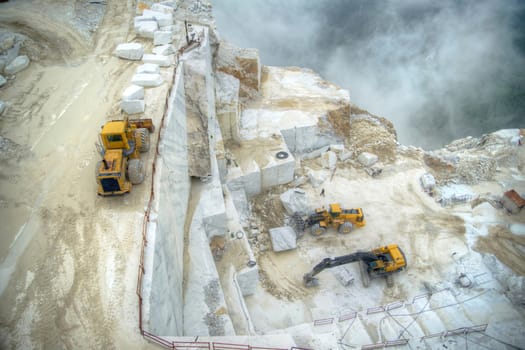 Broad view of the process in the white marble quarries in Carrara Italy