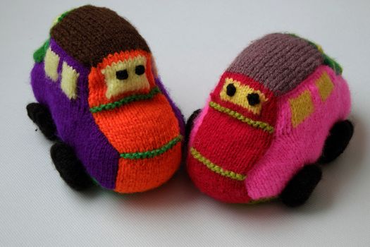 Handmade gift for children, two colorful baby car knit from yarn, funny emotion on couple car, homemade toy as amazing present