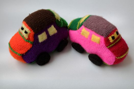 Handmade gift for children, two colorful baby car knit from yarn, funny emotion on couple car, homemade toy as amazing present