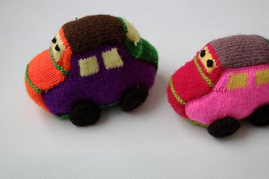 Handmade gift for children, two colorful baby car knit from yarn, funny emotion on couple car, homemade toy as amazing present