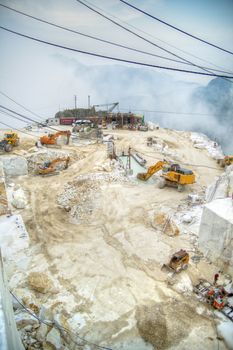 Broad view of the process in the white marble quarries in Carrara Italy