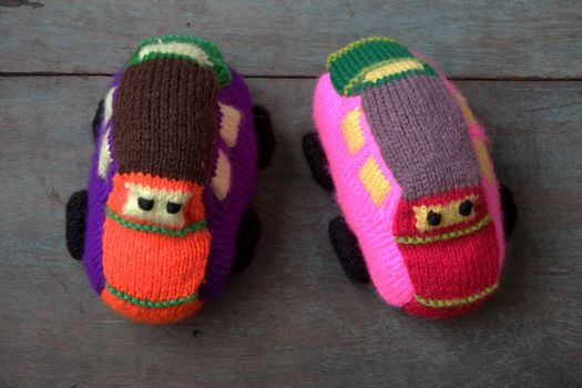 Handmade gift for children, two colorful baby car knit from yarn, funny emotion on couple car, homemade toy as amazing present