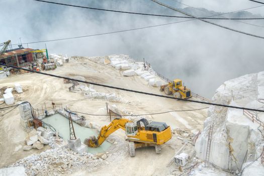 Broad view of the process in the white marble quarries in Carrara Italy