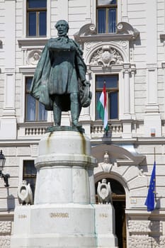 Statue of Lajos Kossuth and governmental building in Pecs, Hungary.